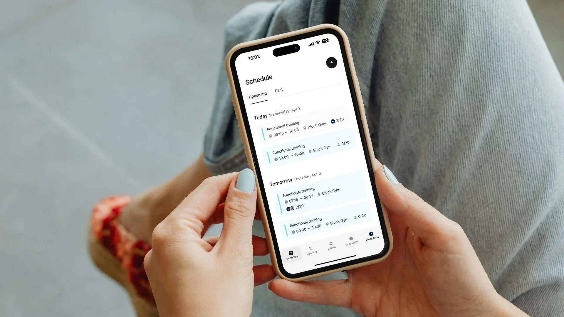 Person using a gym booking software time2book on a smartphone to view upcoming fitness classes and manage their training schedule