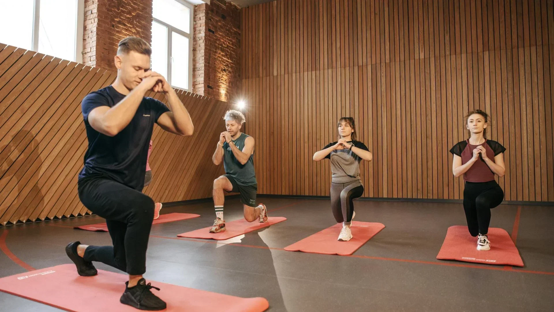 Group fitness class in a modern studio, showing clients attending a scheduled session—highlighting the benefits of consistent attendance through online booking systems