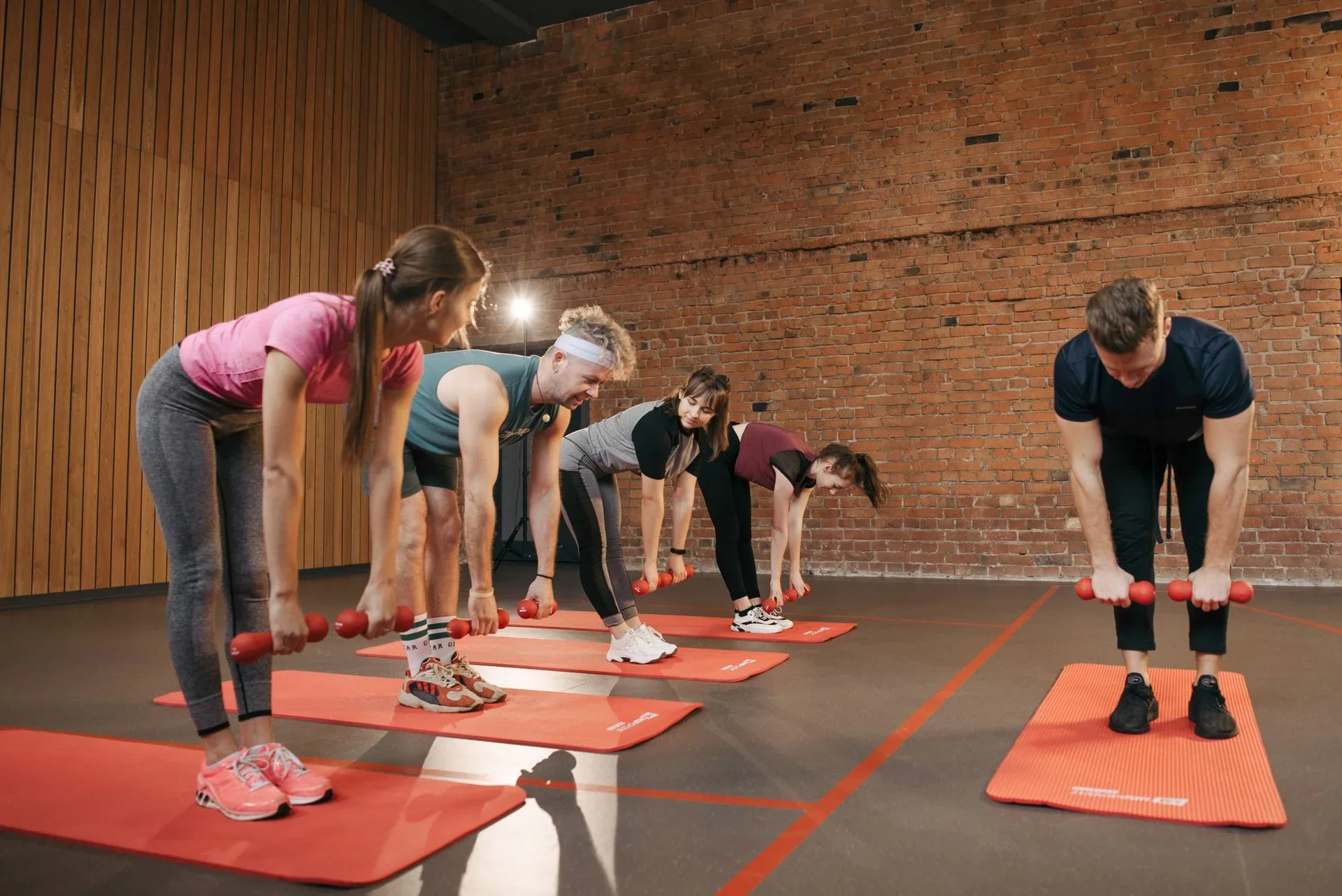 Modern fitness studio interior with people training together – fitness studio names ideas for 2026
