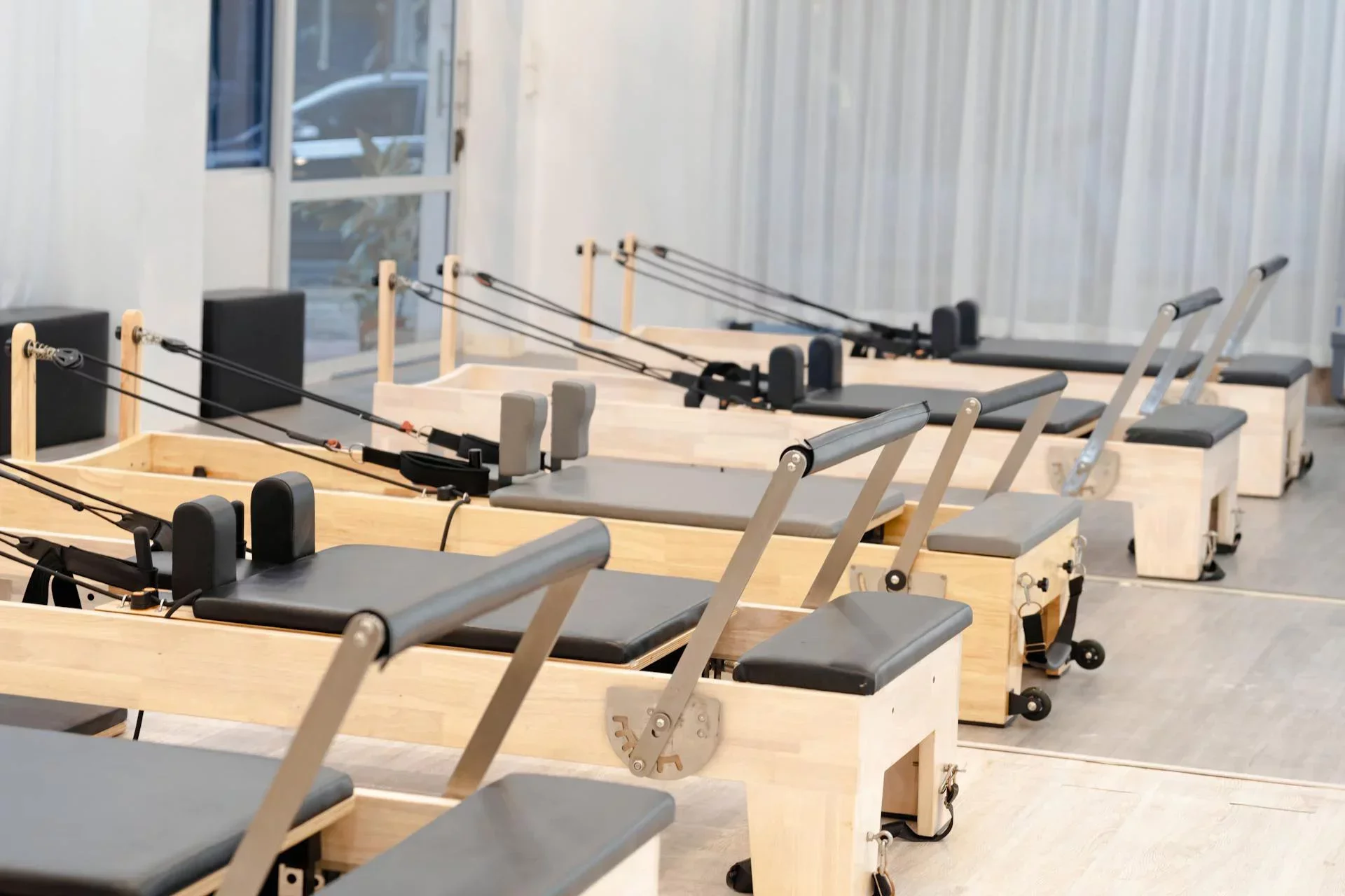 Small Pilates studio with reformer machines set up for group classes – modern Pilates studio equipment 2025