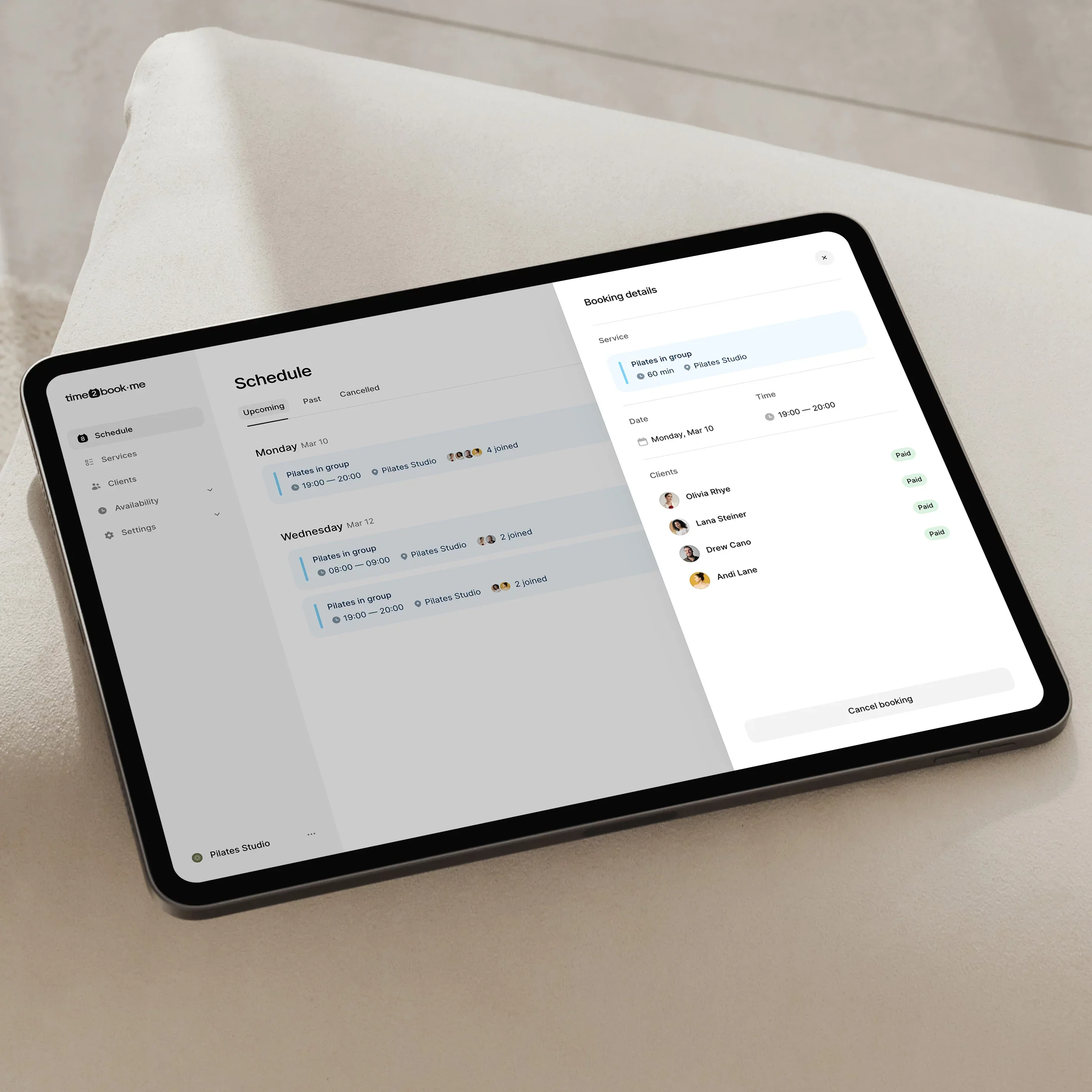 Tablet showing time2book studio schedule with upcoming classes and client payment status